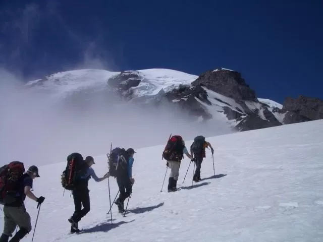 Group of climbers hiking on snow to Camp Muir